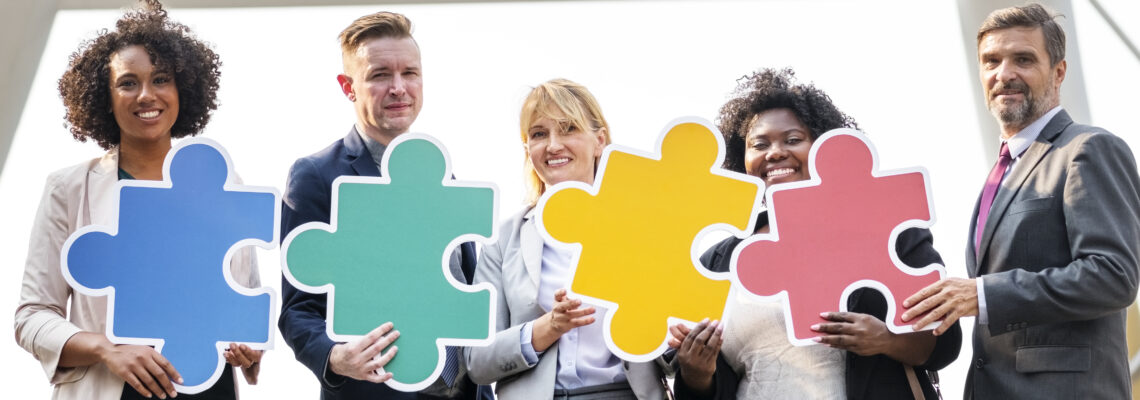 business people connected by puzzle pieces