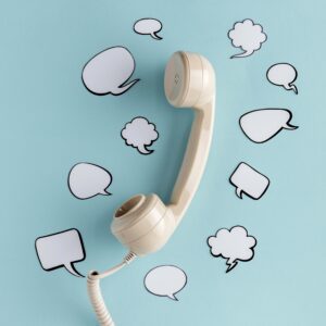 flat lay chat bubbles with telephone receiver